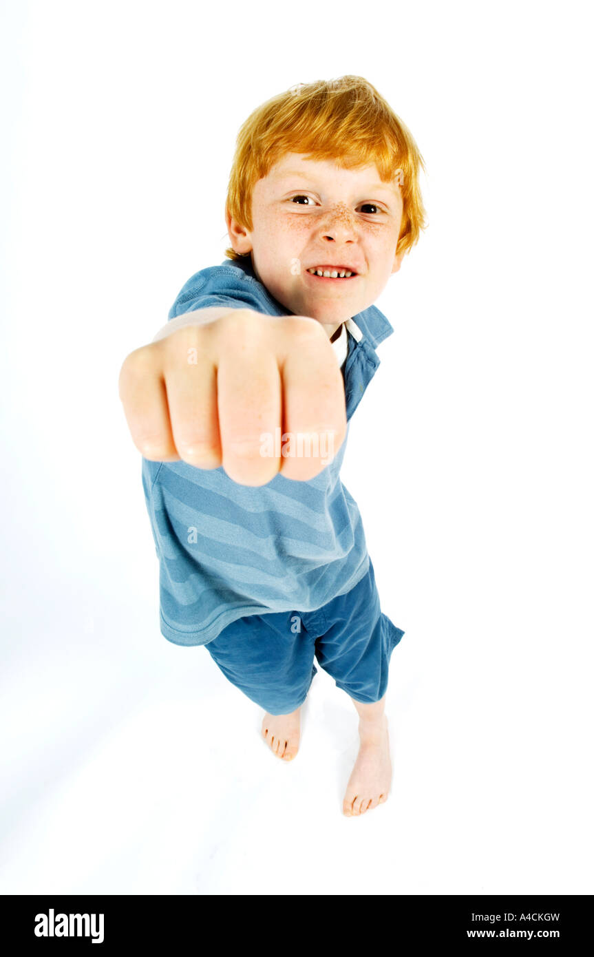 Young boy punching forward in to the air Strike, punch, power Stock