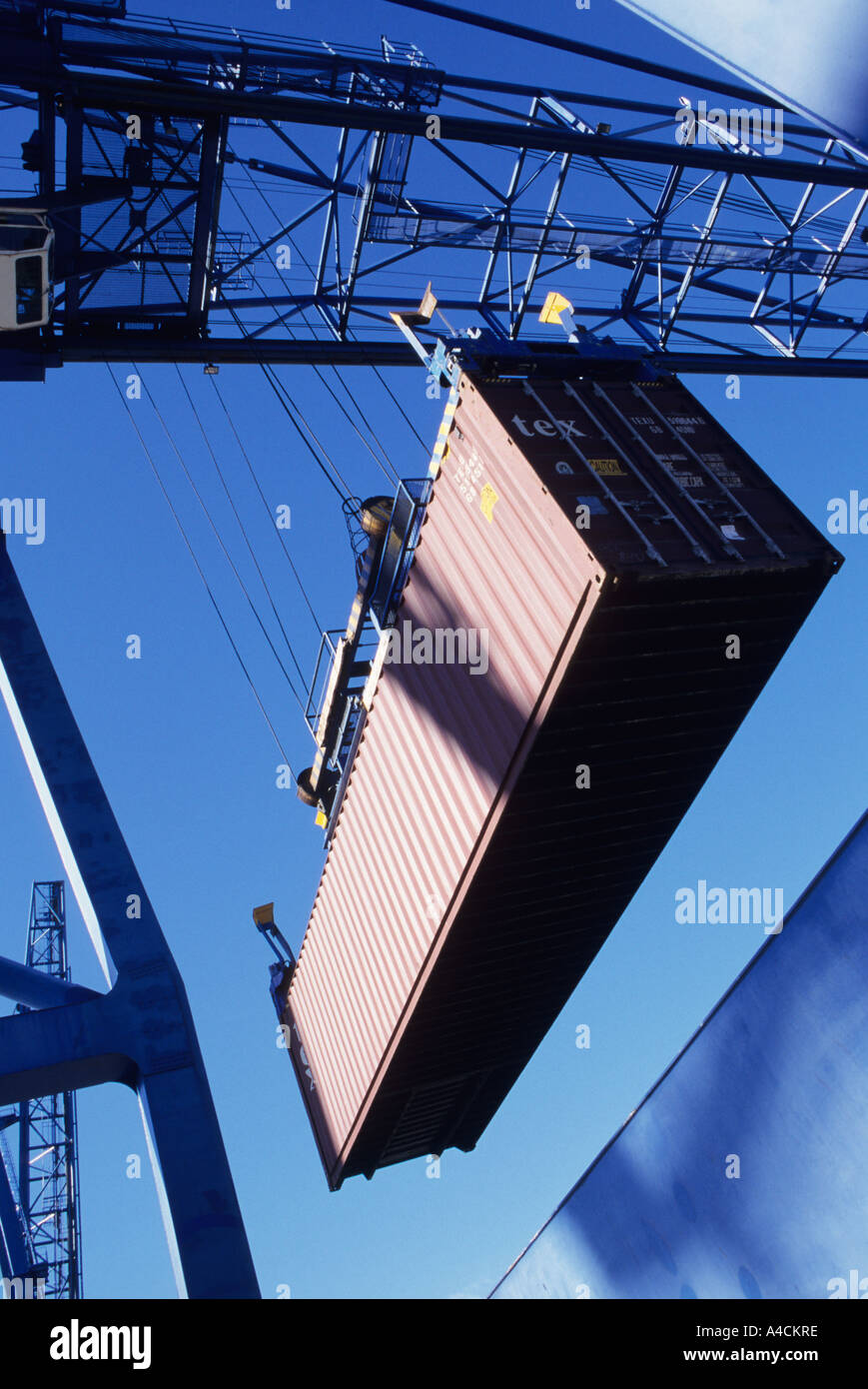 Loading container onto freighter Stock Photo