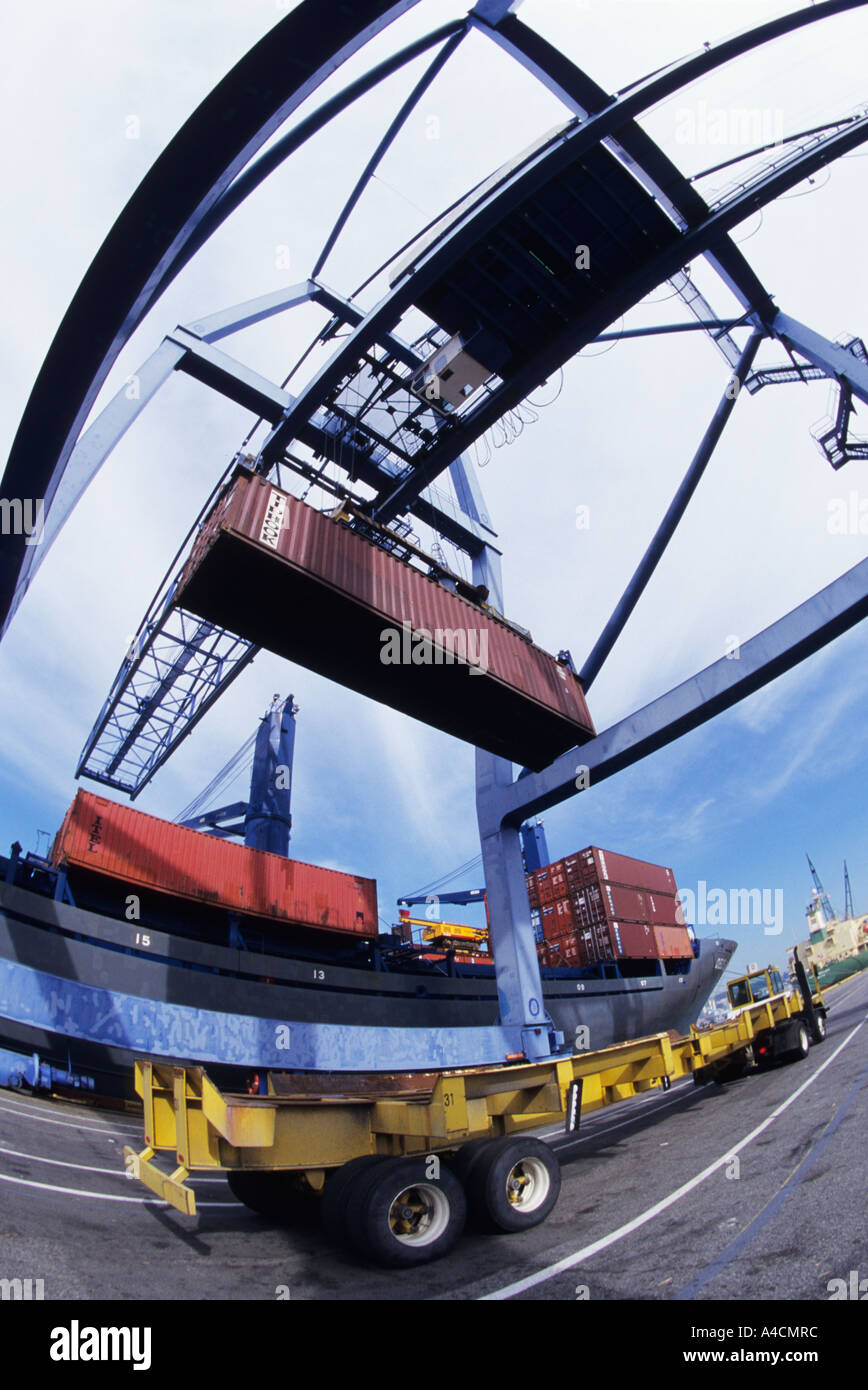 Loading container onto freighter Stock Photo - Alamy