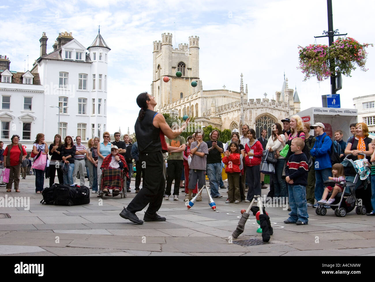 Street performer juggling in Cambridge market square, England Stock Photo