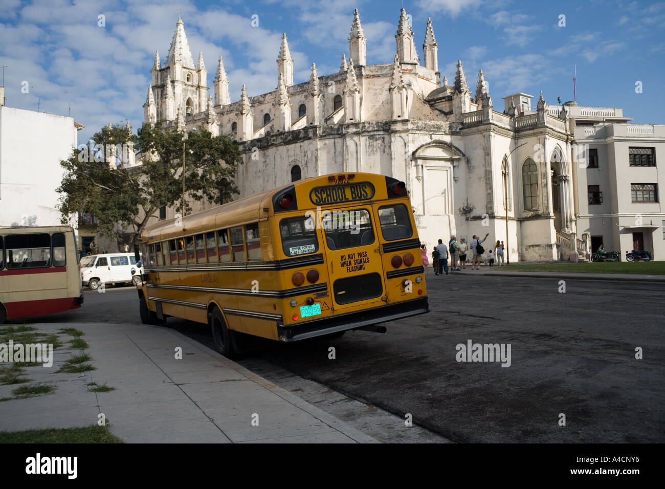 School bus with the church of Santo Angelo Custodio ,central Havana,Cuba Stock Photo