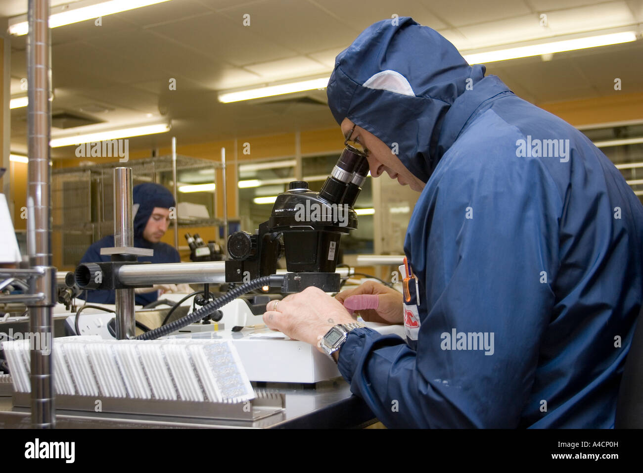 Technician working on micro circuit at Cmac Micro Technology in Great Yarmouth, England. Stock Photo