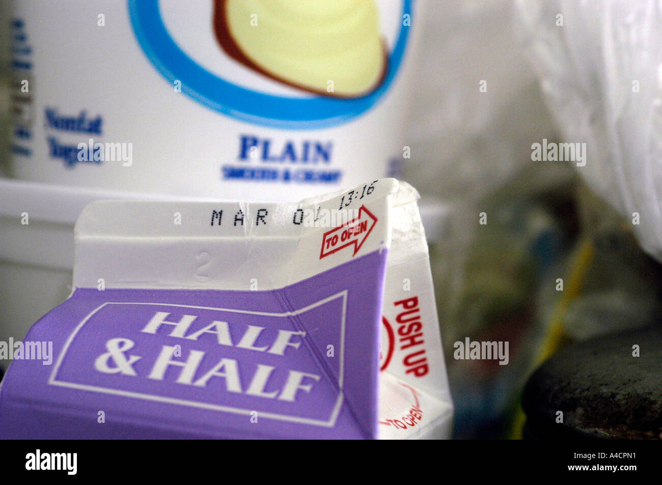 An opened container of half and half The container shows the expiration