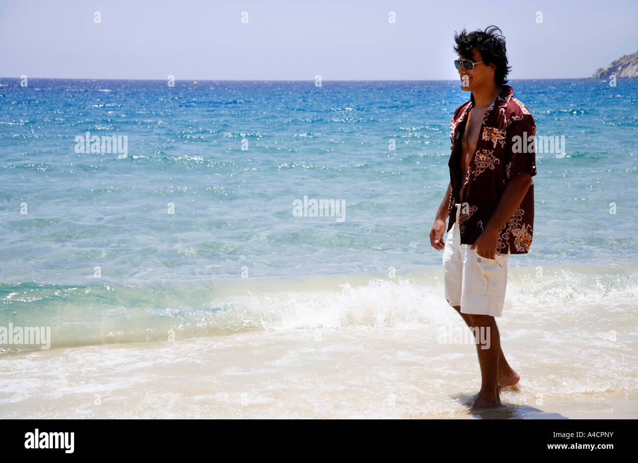 Man walking on the beach Stock Photo - Alamy