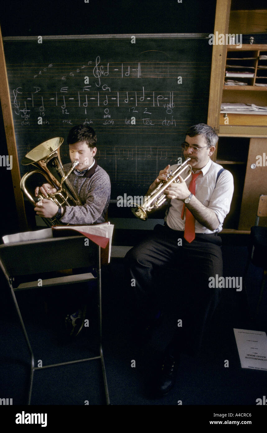 TEACHER & STUDENT PLAYING BRASS INSTRUMENTS IN MUSIC CLASS, HOLYROOD SCHOOL, GLASGOW., 1990 Stock Photo