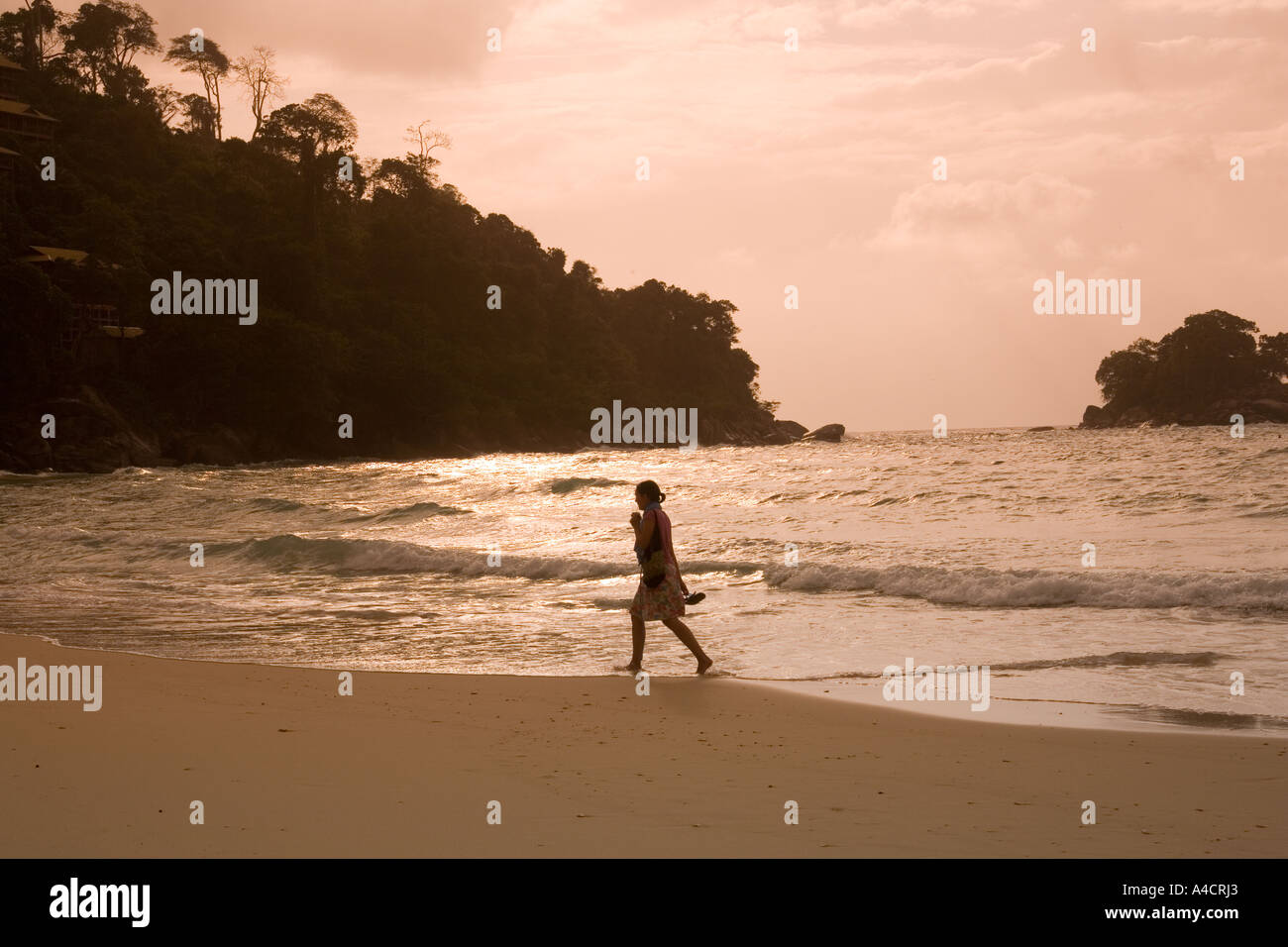 Malaysia Pulao Tioman Salang village beach sunset woman walking Stock Photo