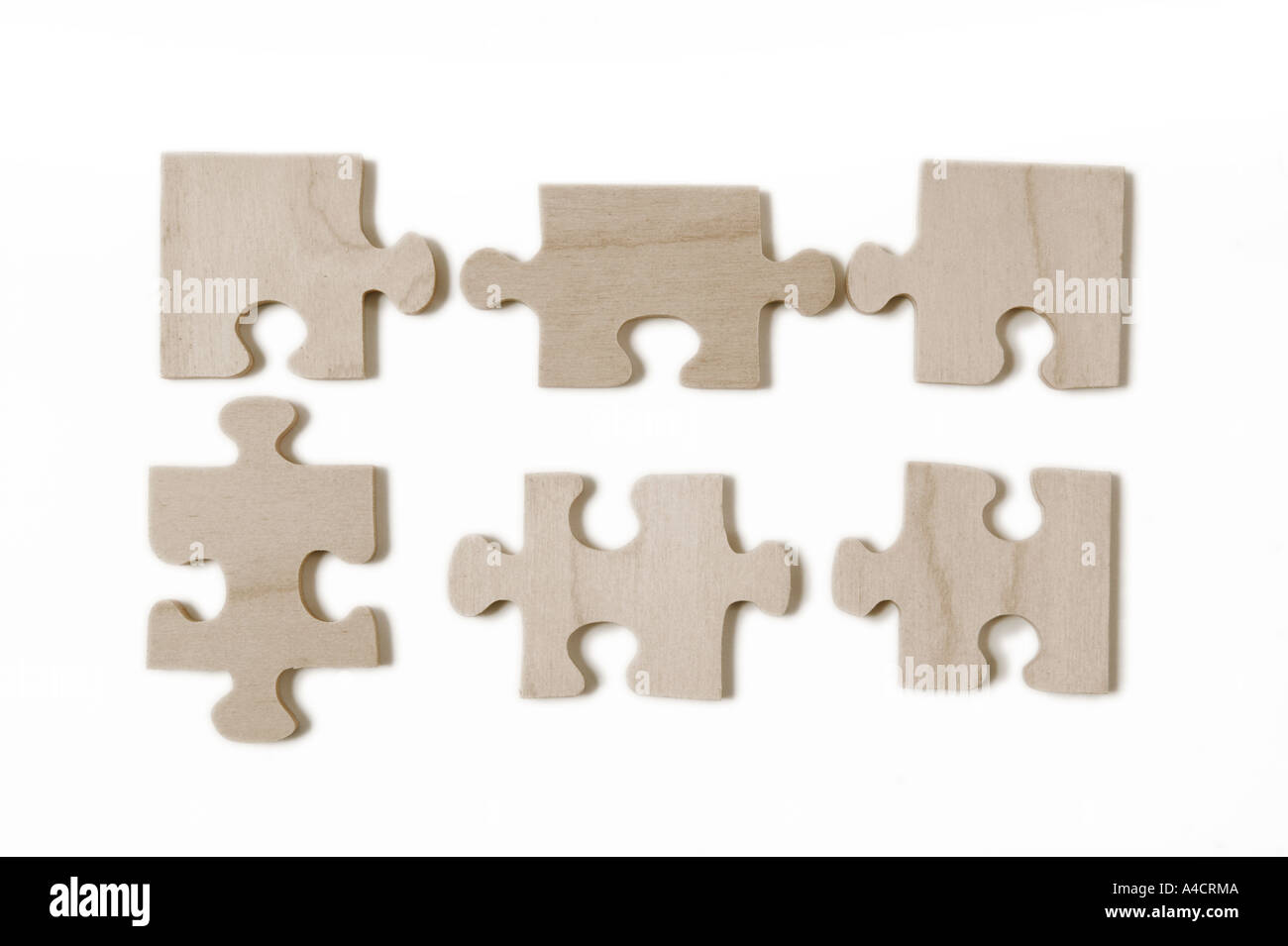 irregular pieces of a wooden jigsaw puzzle in flat subtle lighting