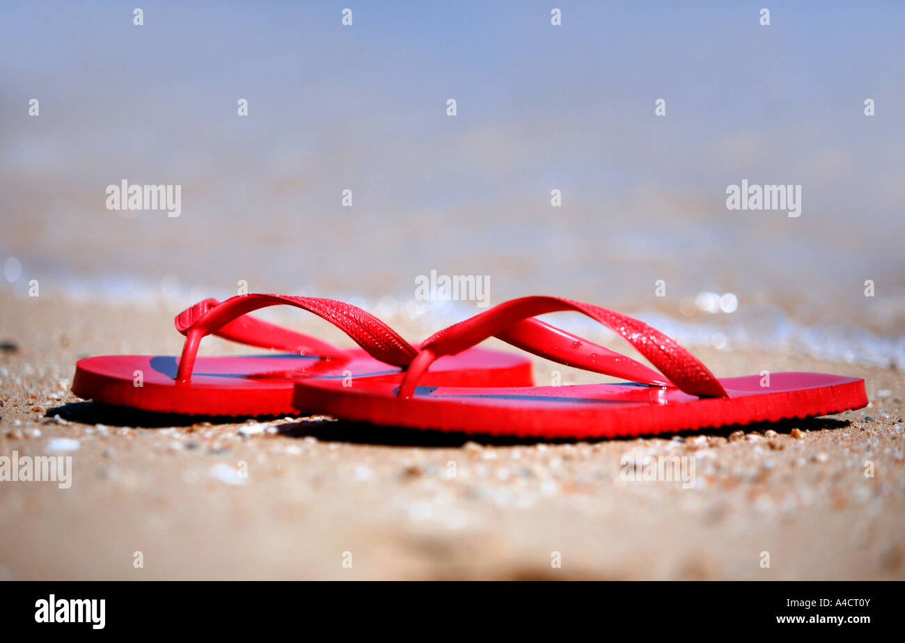 Flip flops on the beach Stock Photo - Alamy