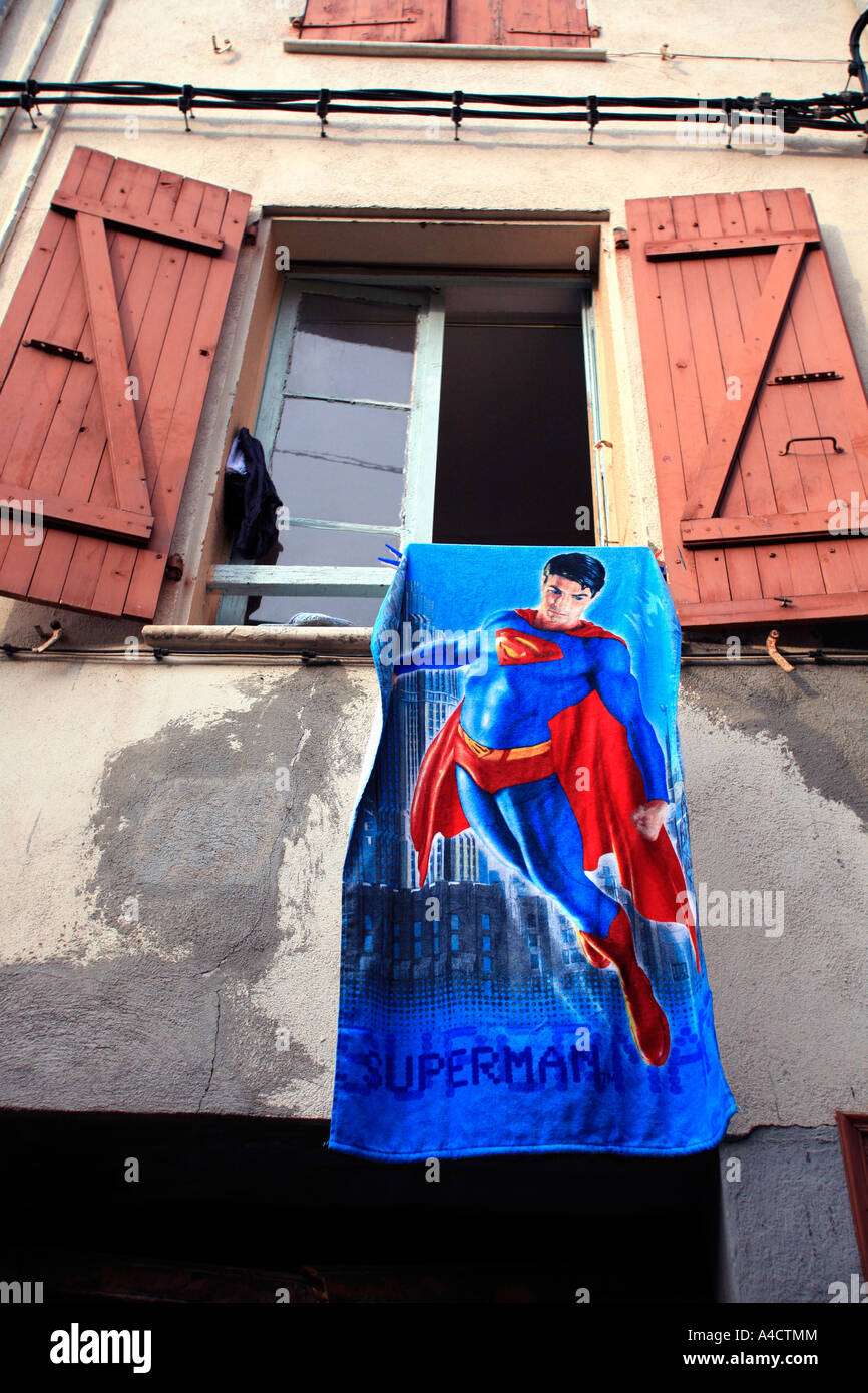 Window with superman towel hanging out Perpignan France Stock Photo