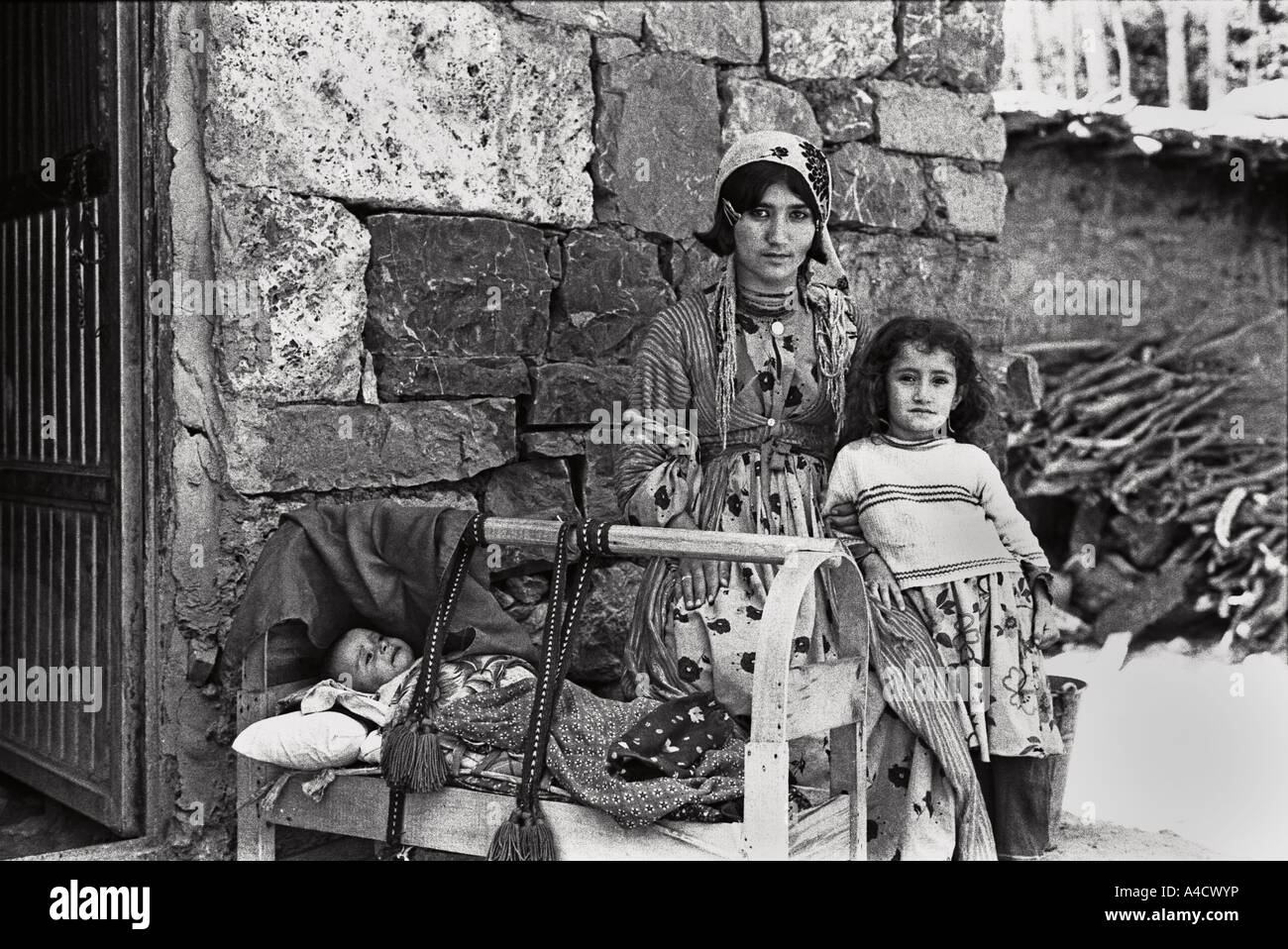 July 1987 Beytussebap south east Turkey Kurdistan A Kurdish mother and her baby with her sister outside their home Stock Photo