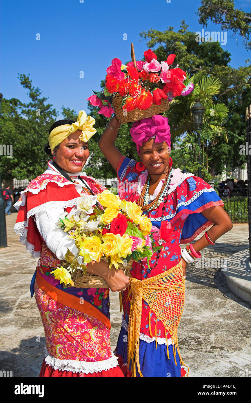 Two women wearing colourful traditional clothing, Plaza de Armas, Havana, La Habana Vieja, Cuba Stock Photo