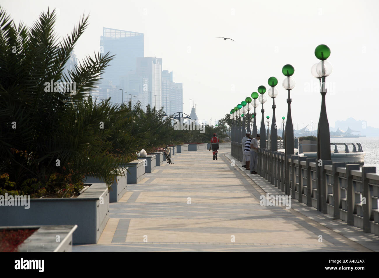 A person walking along the Corniche, Abu Dhabi city, UAE Stock Photo