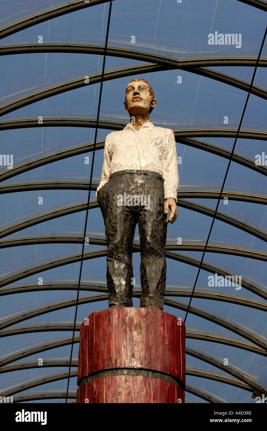 Modern wooden sculpture of man in shopping mall Berlin Stock Photo