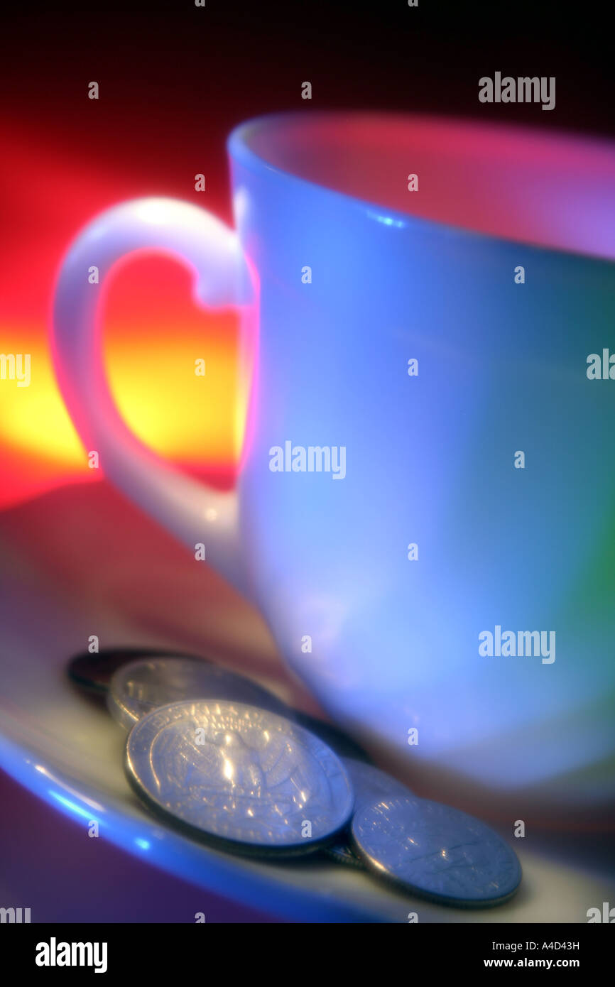 Cup on saucer and coins Stock Photo Alamy