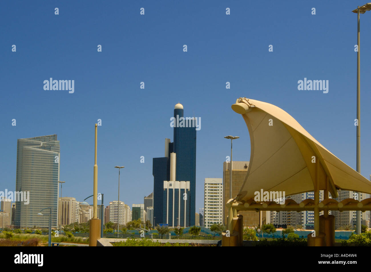 Corniche with modern high rise buildings and futuristic sun shade Abu Dhabi UAE Stock Photo