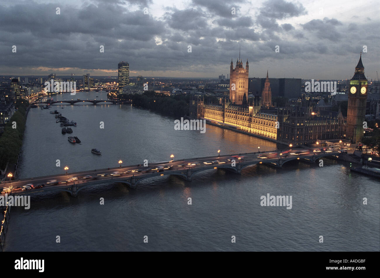 Dusk over The River Thames with views of the illuminated Houses of Parliament and Big Ben, London, UK Stock Photo
