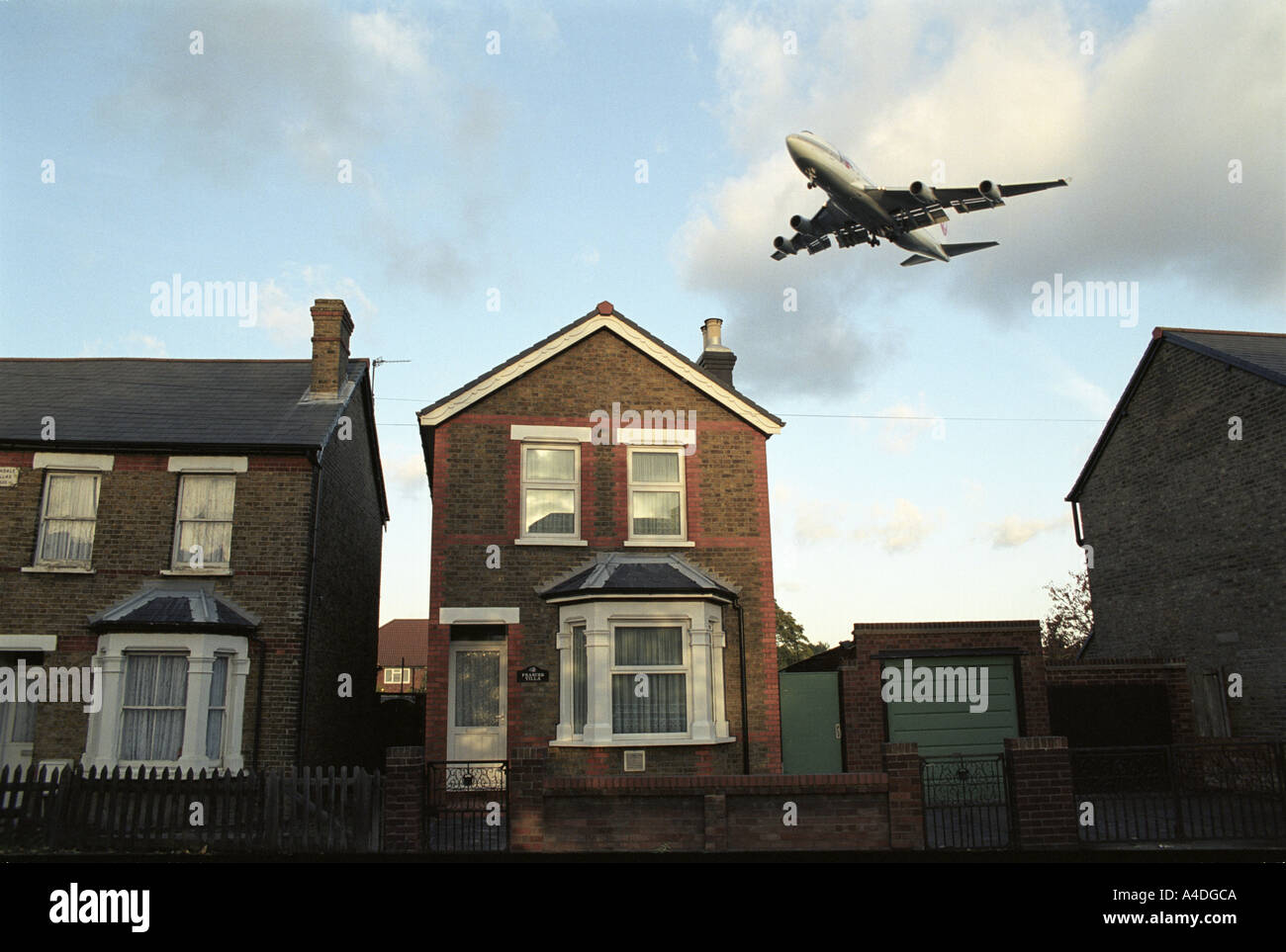 A plane coming in to land only a few metres over a  double glazed house near heathrow hounslow  2001 uk Stock Photo