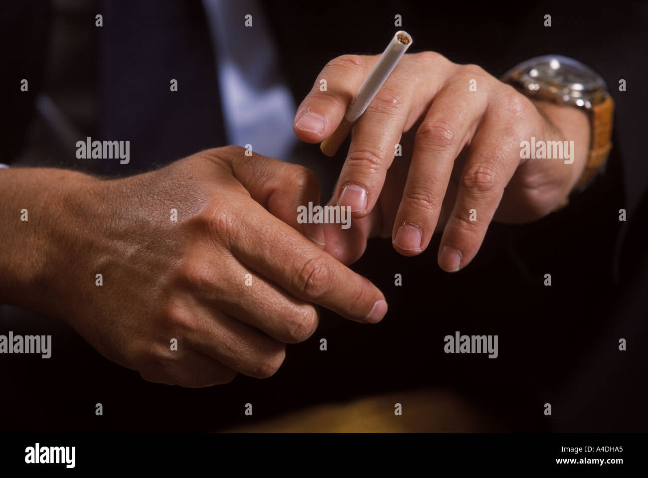 cigarette between middle and ring finger Holding cigarette between fingers hi-res stock photography and images