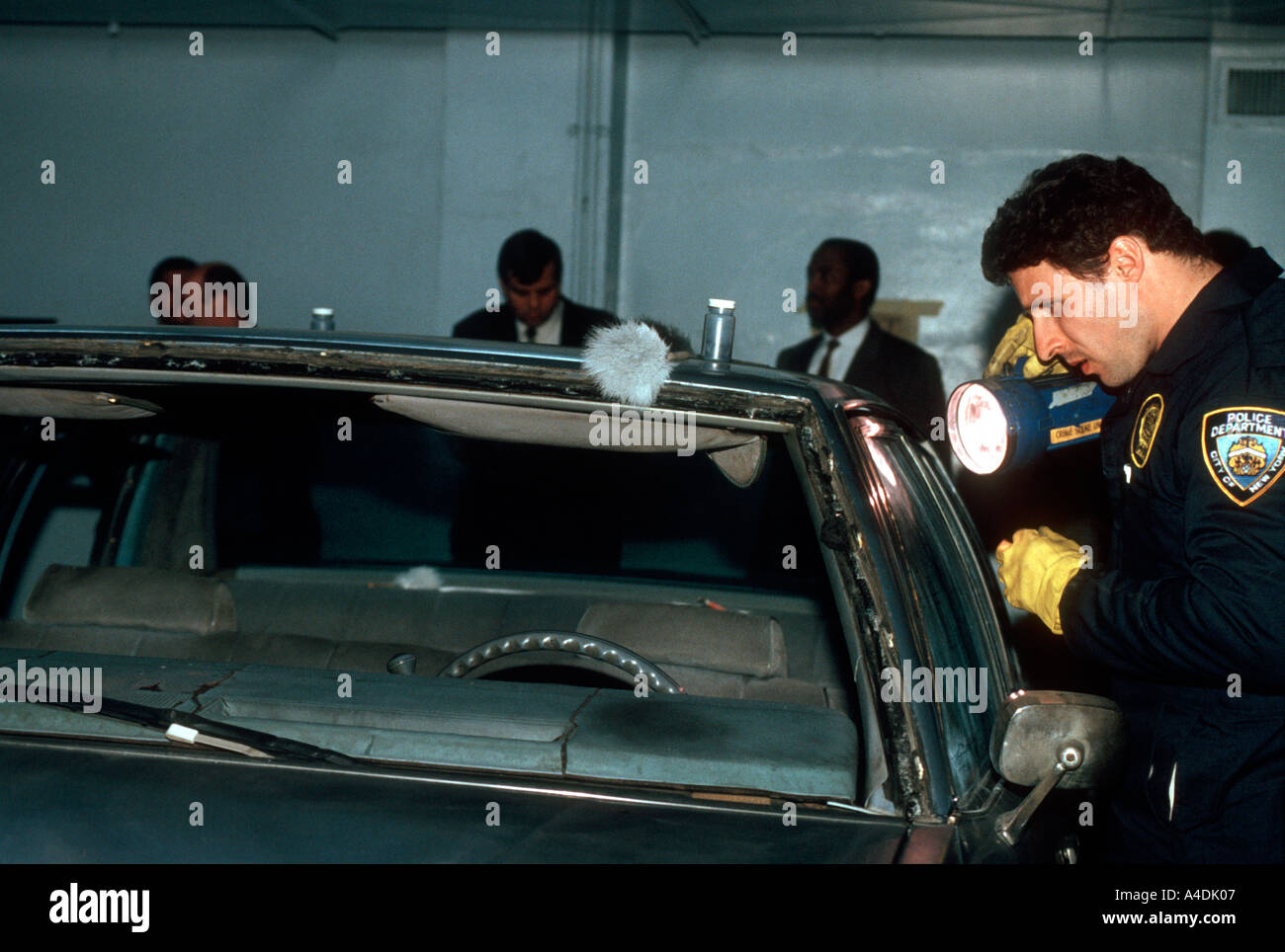 Members of the NYPD Crime Scene Unit investigate the automobile used by