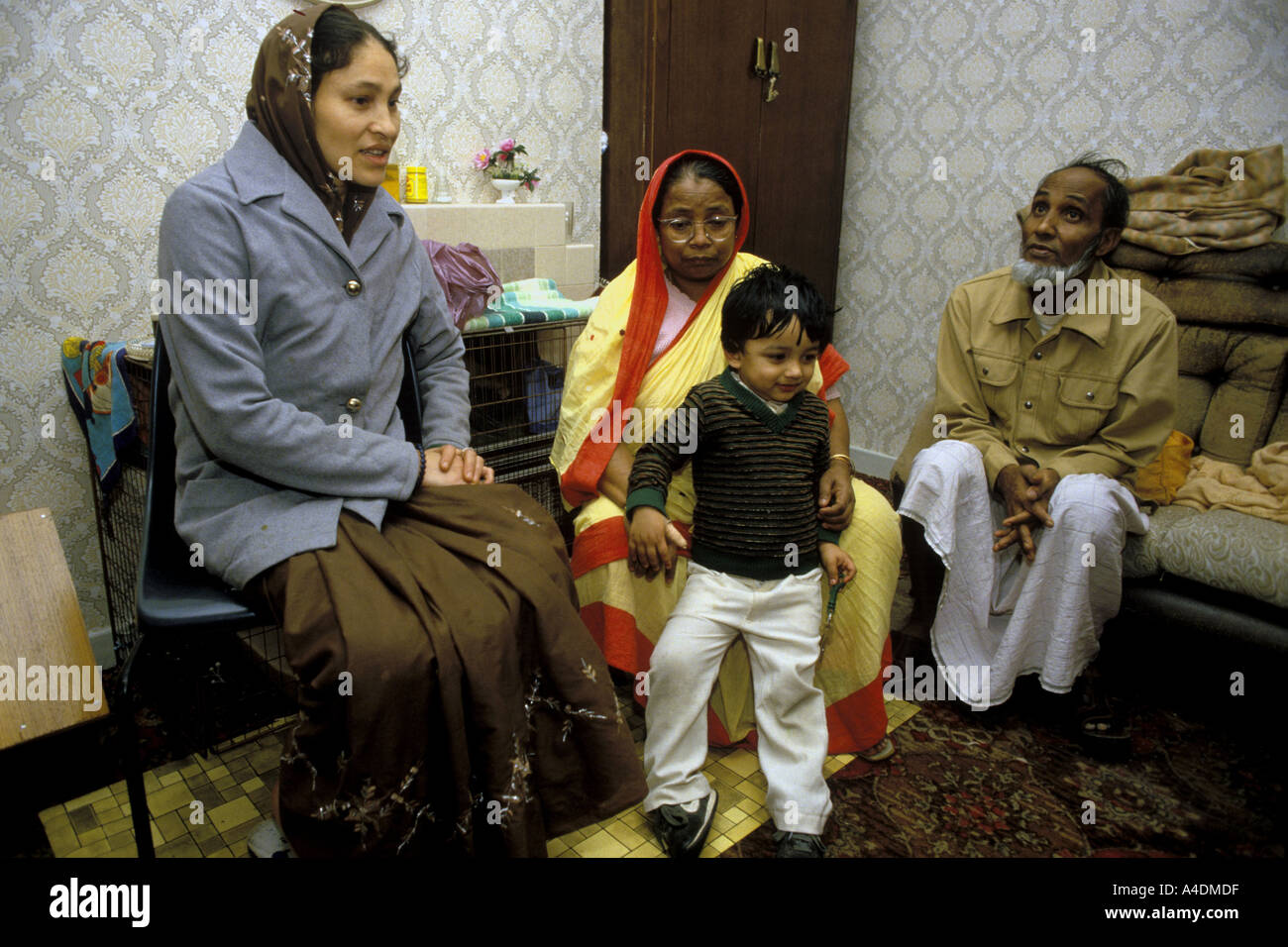 A Bangladesh family at home in Tower Hamlets.Their home suffers from dreadful damp, East London, UK Stock Photo
