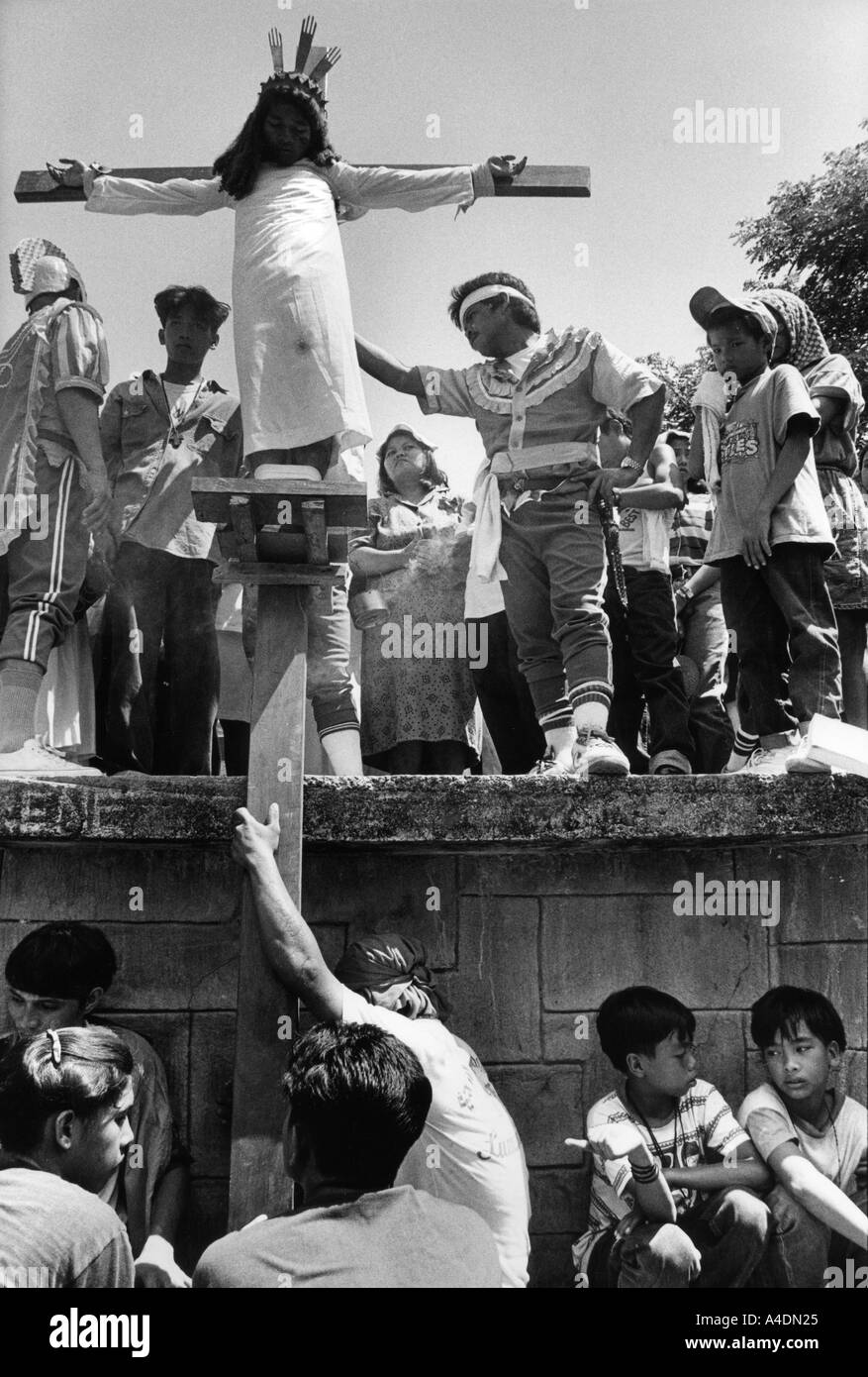 A penitant is nailed to his cross by members of his family and friends. Kapitangan-Paombong, Philippines Stock Photo