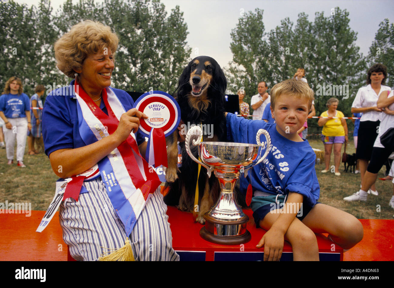 A winning dog with his owners and silver trophy, Scruffts Dog Show ridiculing Crufts, UK Stock Photo