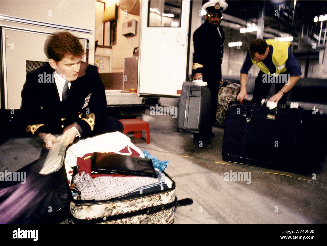Customs officers search baggage, Stansted Airport, UK Stock