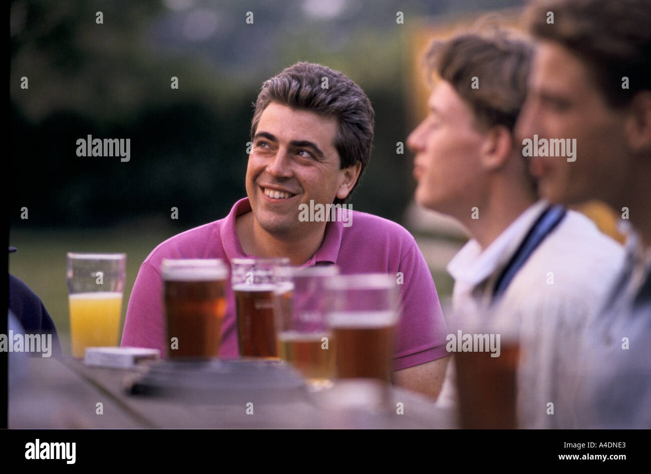 Men drinking beer outdoors at a pub, England Stock Photo