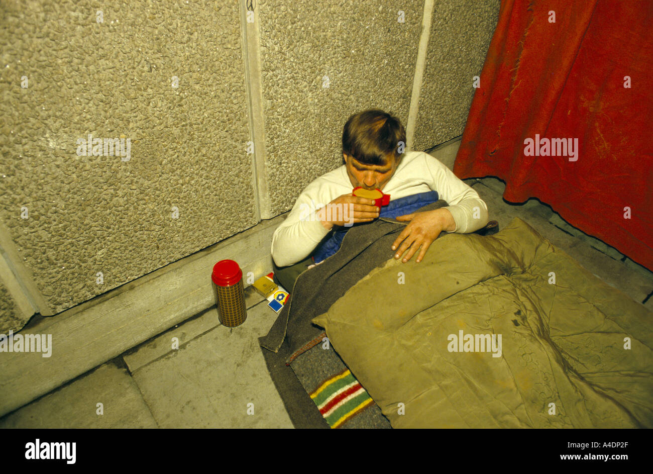 A homeless man drinking a cup of tea from a flask Stock Photo Alamy