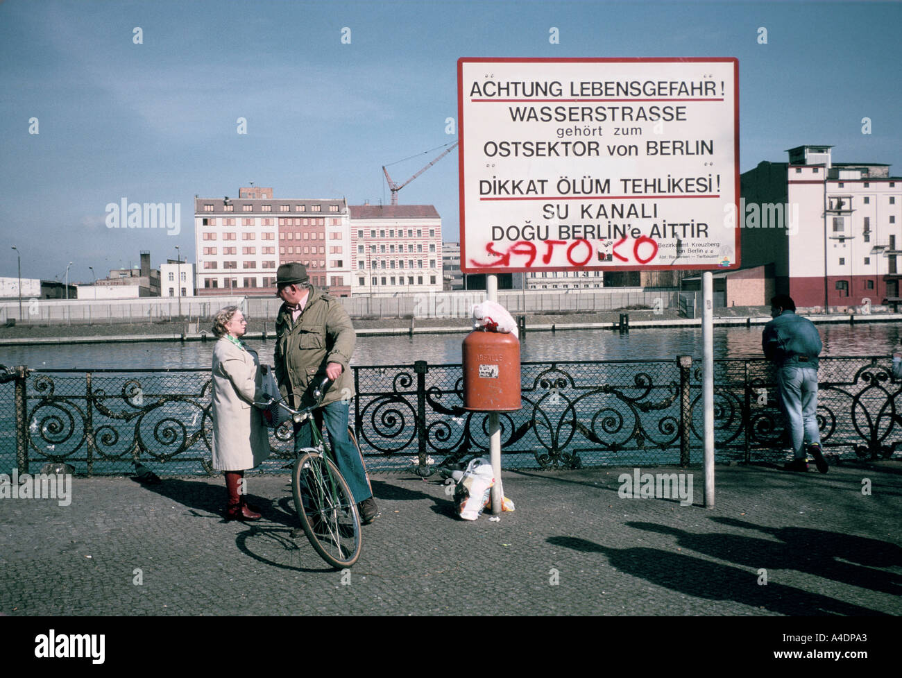 The Berlin wall pre-unification. At Schlesisches Tor  where the water of the Spree is the border with the  DDR, March1989 Stock Photo
