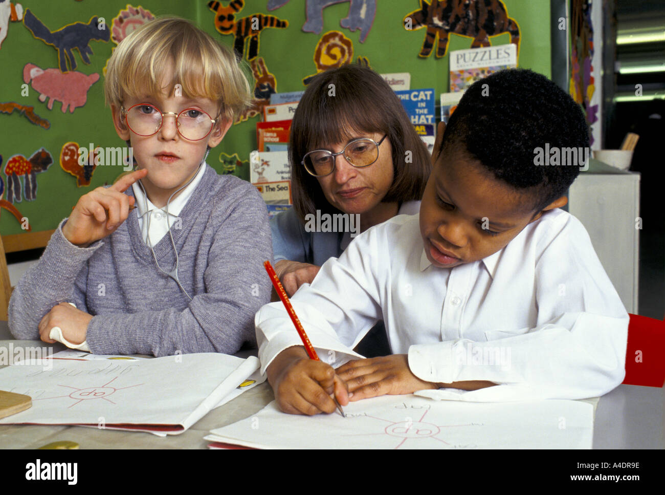 teacher with pupils during class in primary school Stock Photo - Alamy
