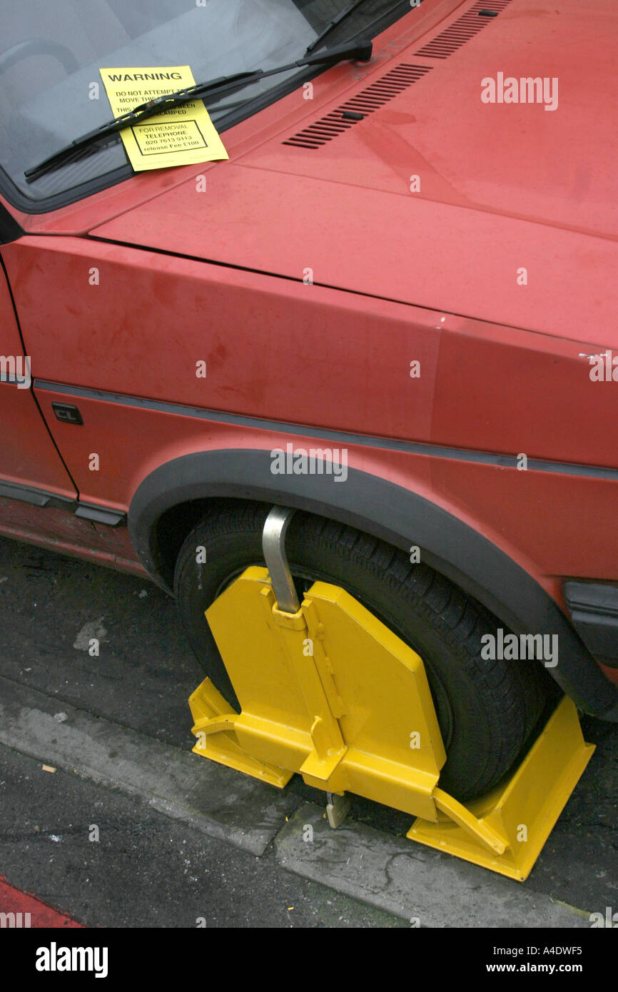 A wheel clamped car in London UK Stock Photo Alamy