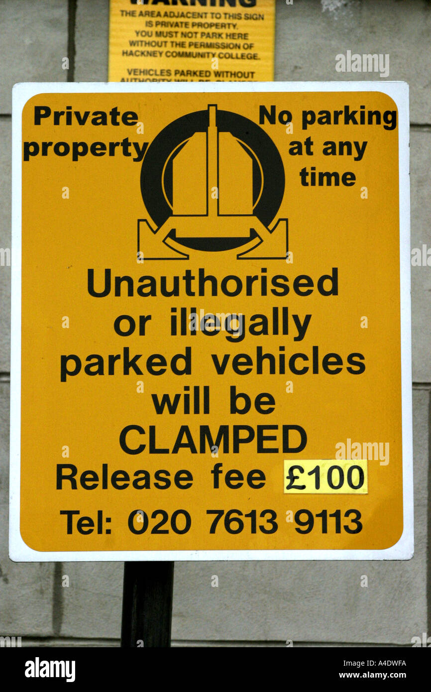 Warning sign threatening wheel clamping for unauthorised parking London UK Stock Photo