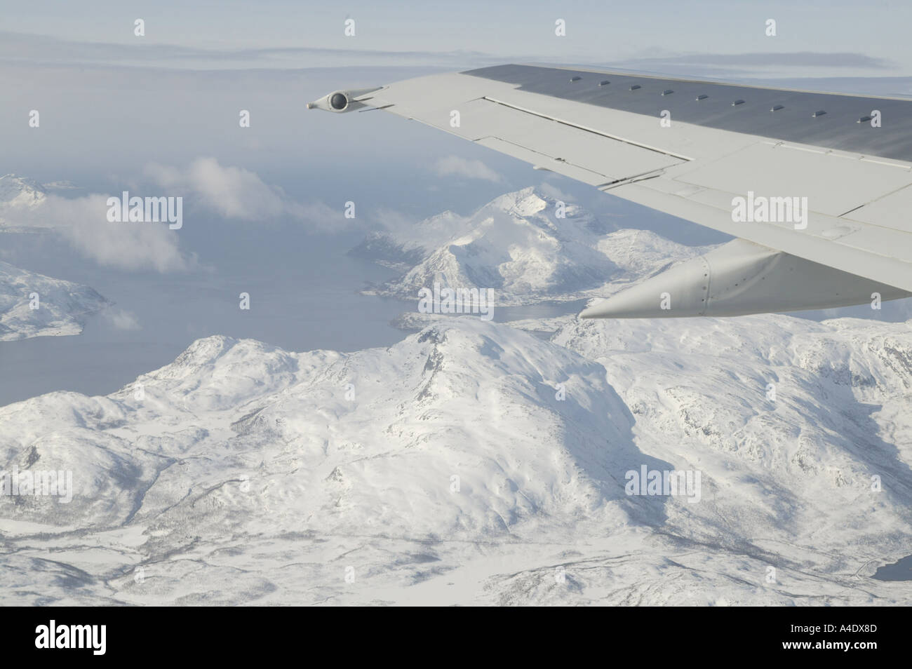 View from plane window over snow covered mountains in Tromso, Norway Stock Photo