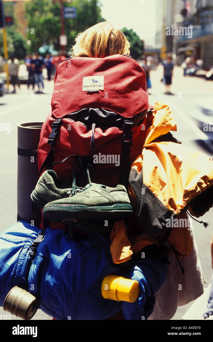 New Zealand Auckland Queen Street young man wearing heavily loaded back pack Stock Photo