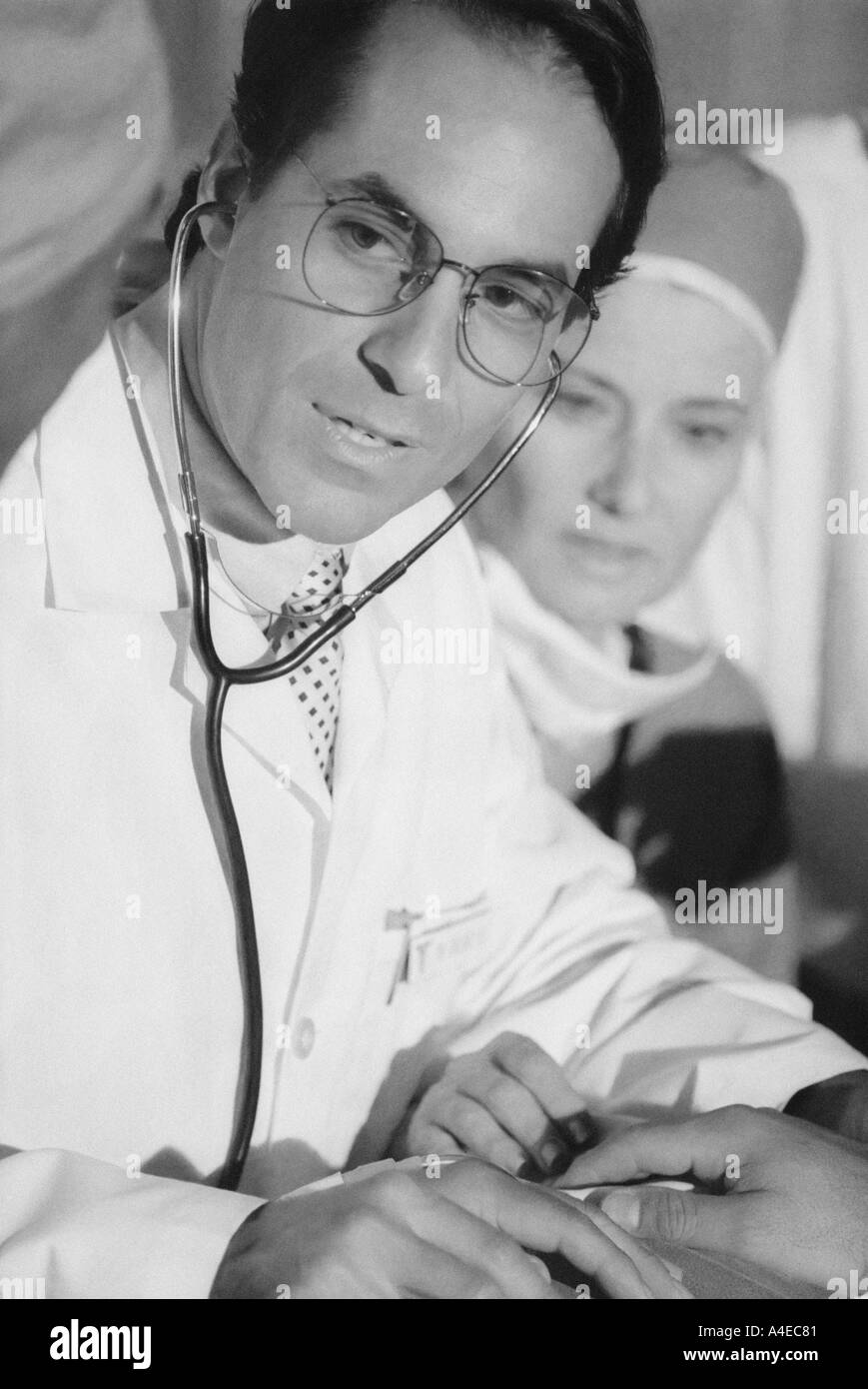 Nurse treating patient Black and White Stock Photos & Images - Alamy