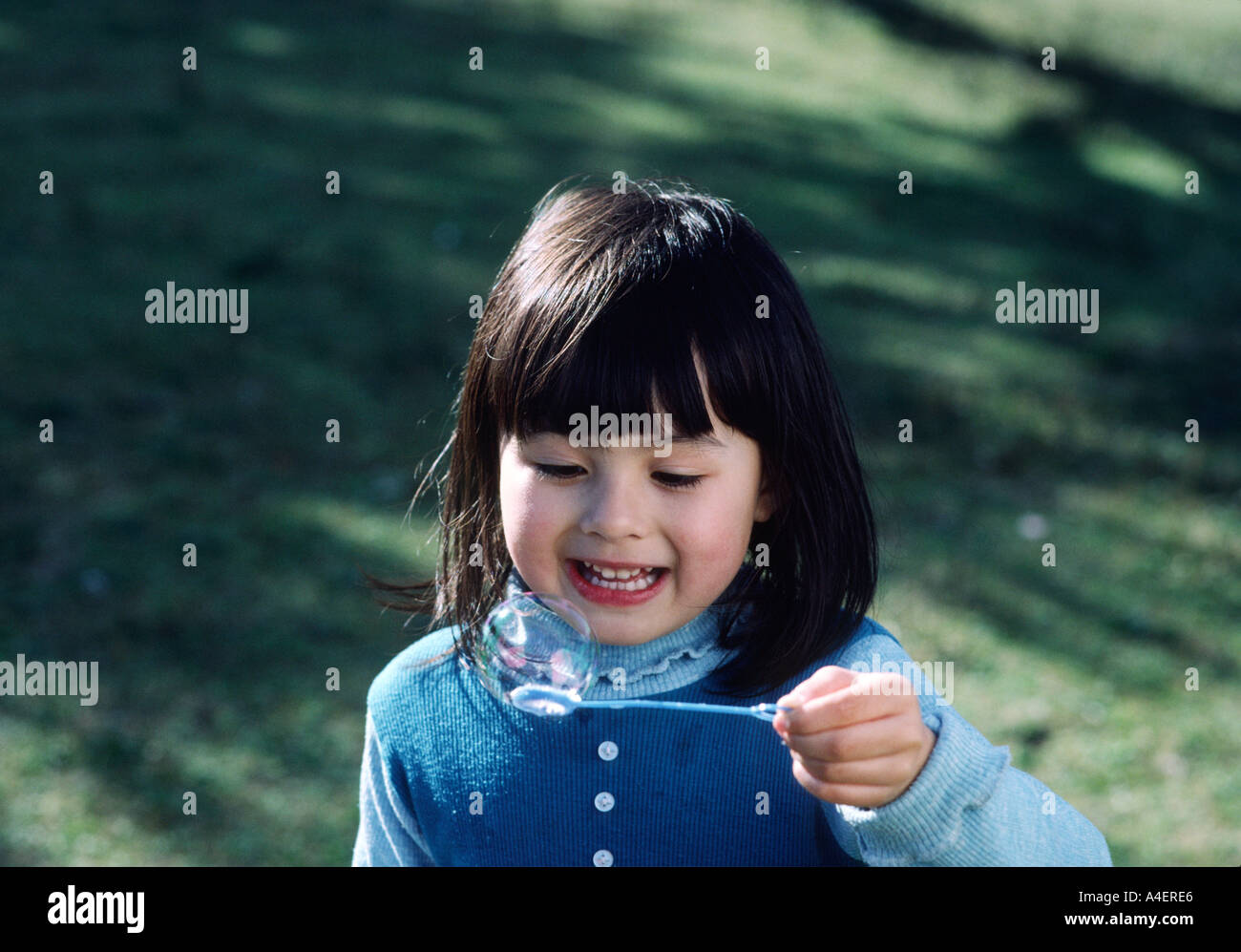 5428 four year old girl with bubble in a park MR 1 San Francisco California USA Stock Photo