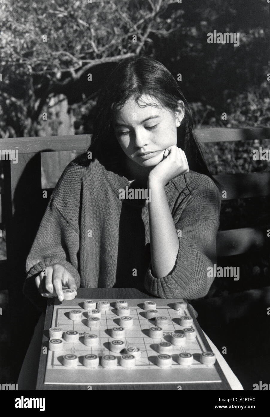 5593 16 twelve year old girl plays Chinese chess game San Francisco California USA MR 1 Stock Photo