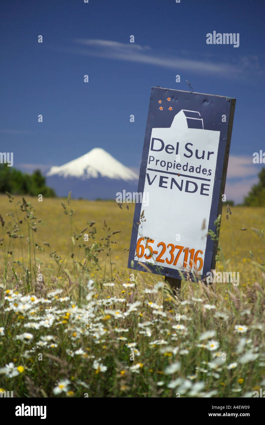 Properties for sale sign board Osorno Volcano in distance near Puerto Varas La Araucania Lake District Chile South America Stock Photo