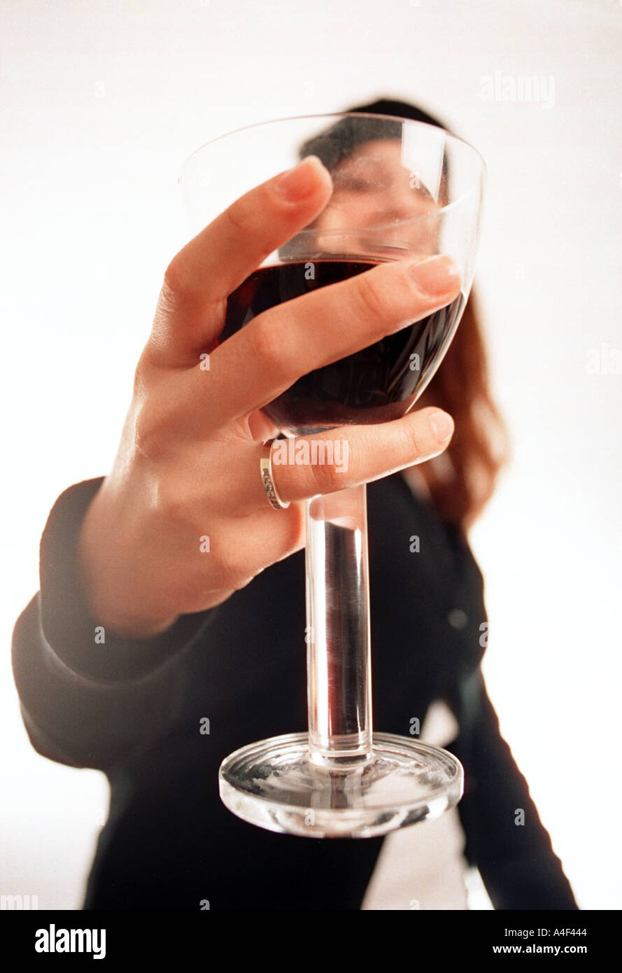 girl holding a glass of red wine Stock Photo - Alamy