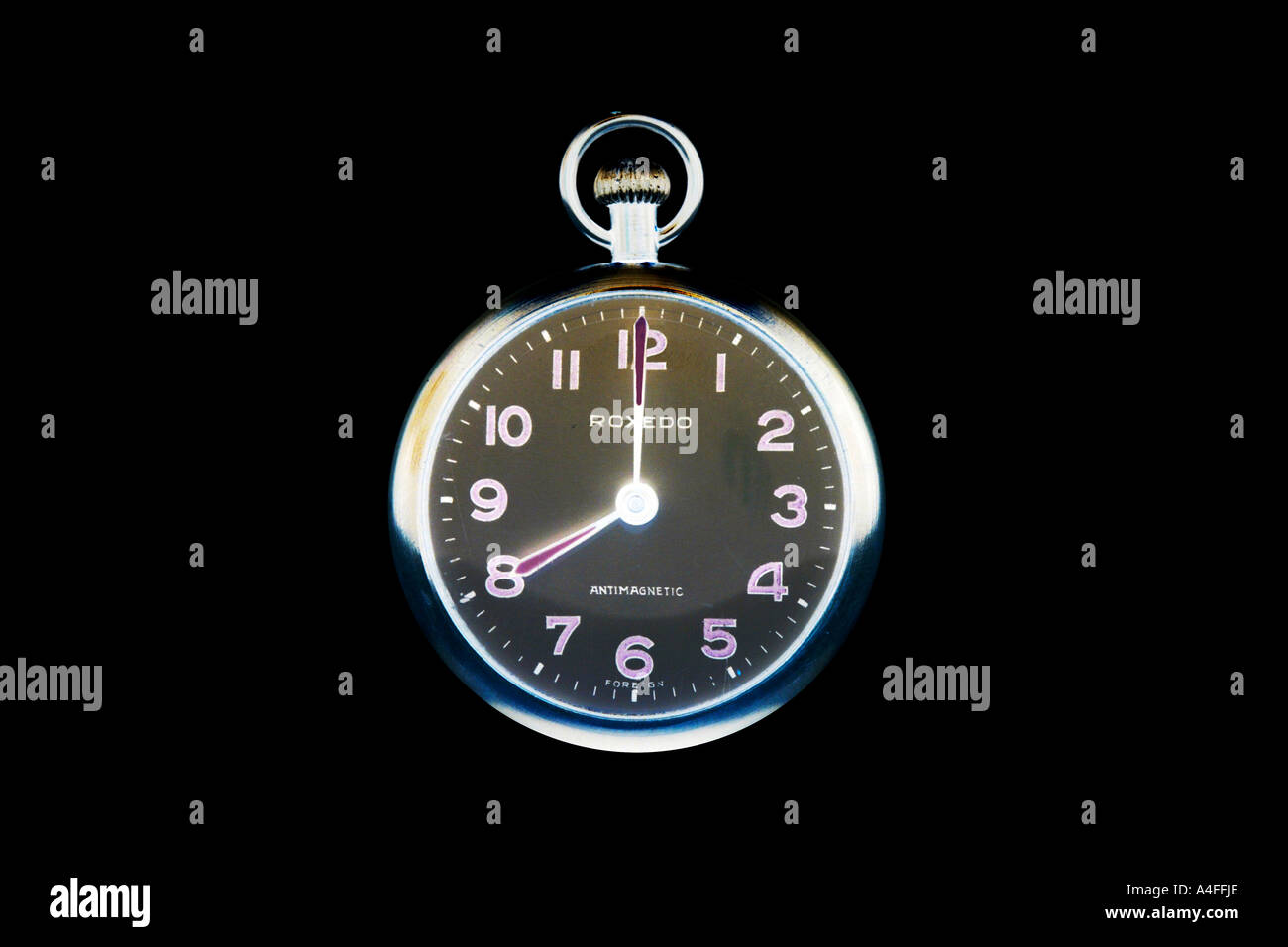 Pocketwatch at 8 o'clock against a black background. Stock Photo