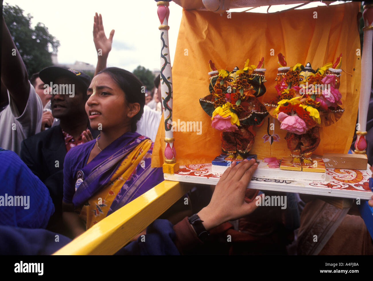Hindu UK Festival Hare Krishna Radha Krishna Devotees touch idol carried in procession London 2004 2000s England HOMER SYKES Stock Photo