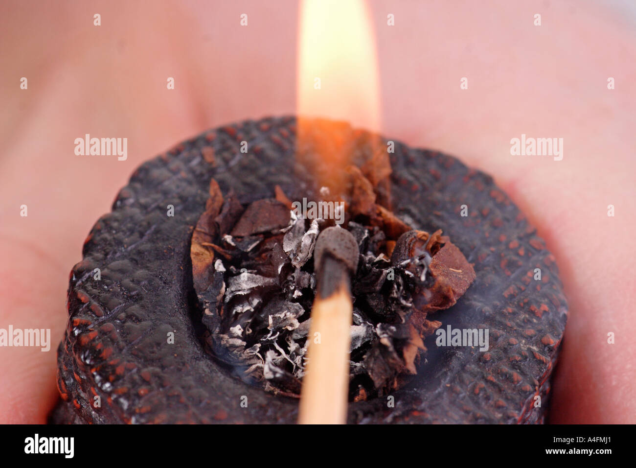 A pipe being lit Stock Photo - Alamy