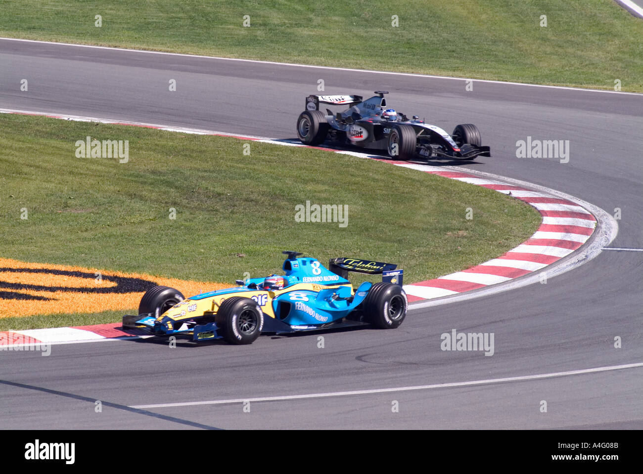 Two Formula 1 Racing Cars Blue Yellow Bodies In Race Corner Gilles Stock Photo Alamy
