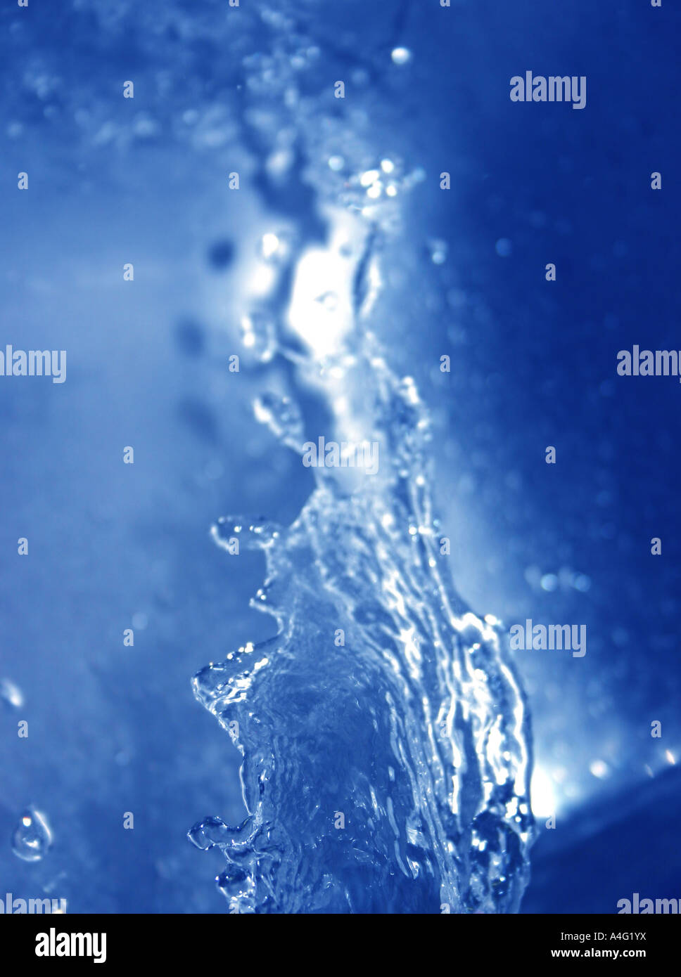 Water splashes upwards that has a blue tint Stock Photo Alamy
