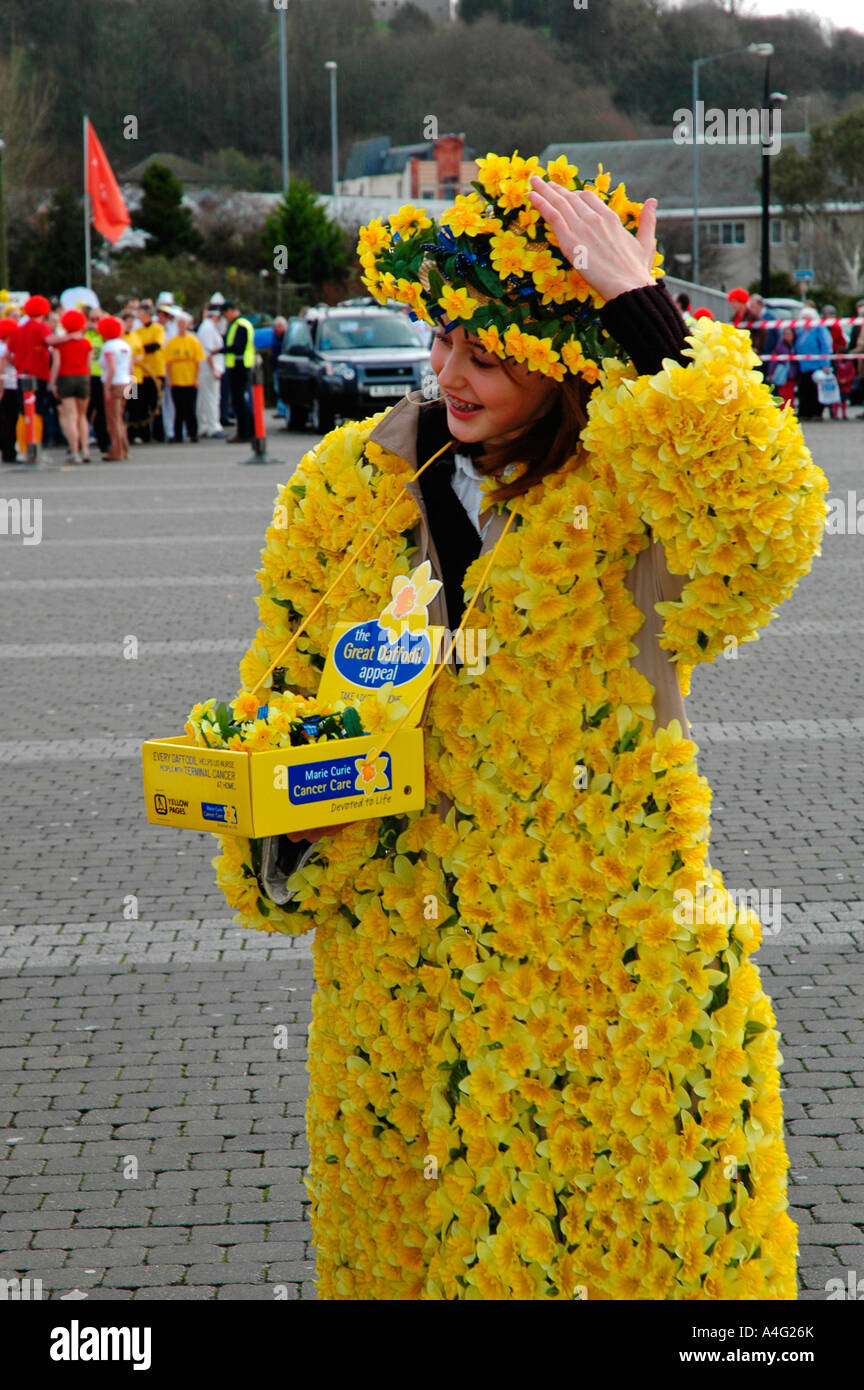 a young girl covered in daffodils collects for the " marie curie