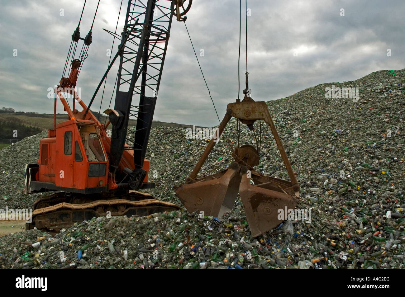 a crane lifting old glass bottles ready to be recycled in cornwall