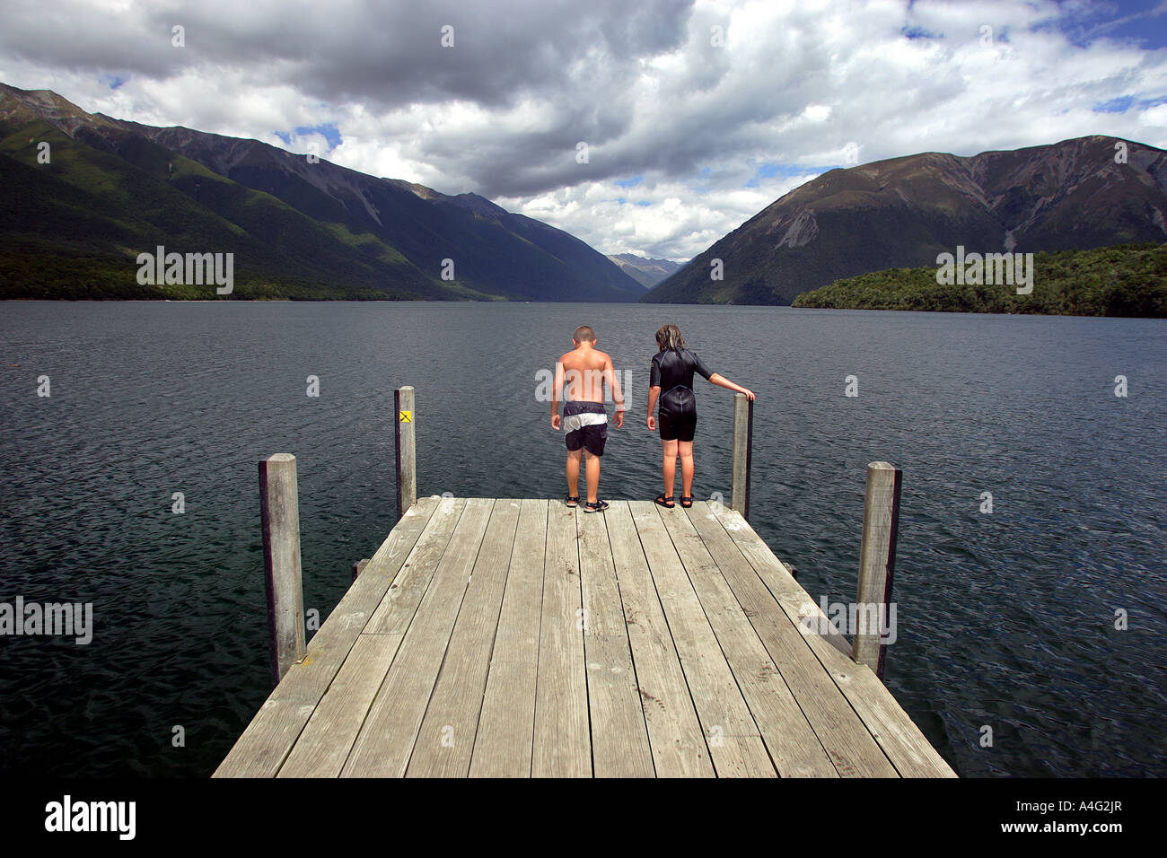 Children prepare to leap into Lake Rotoiti in Nelson Lakes National Park New Zealand Stock Photo