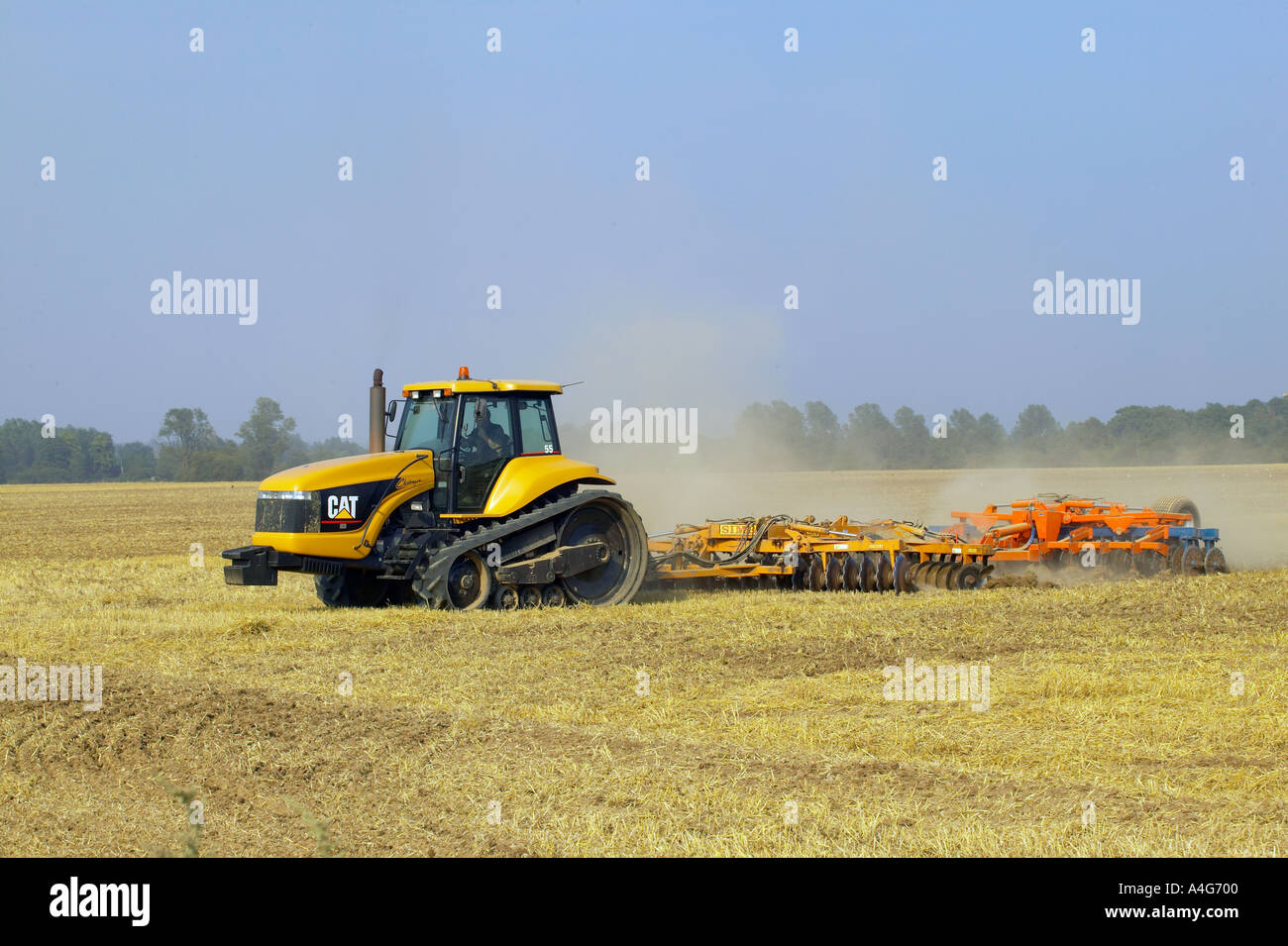 Caterpillar tractor and disc harrow Stock Photo Alamy