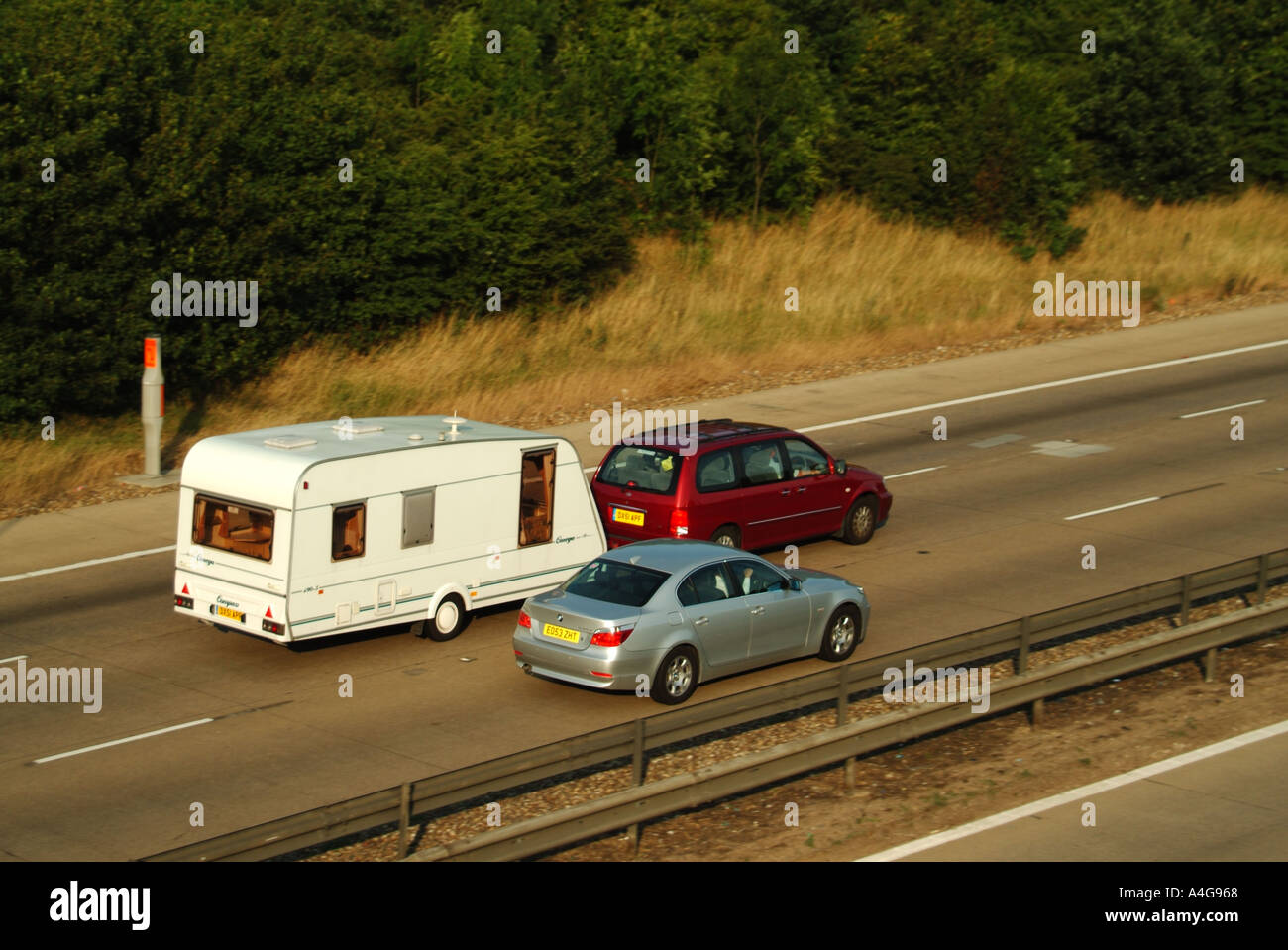 M25 car overtaking car towing caravan Stock Photo 2034023 Alamy